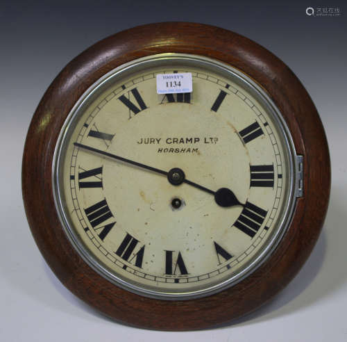 An early 20th century oak cased circular wall timepiece with thirty hour movement, the painted