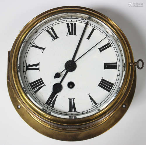 An early 20th century brass circular cased ship's timepiece with eight day chain fusee movement, the