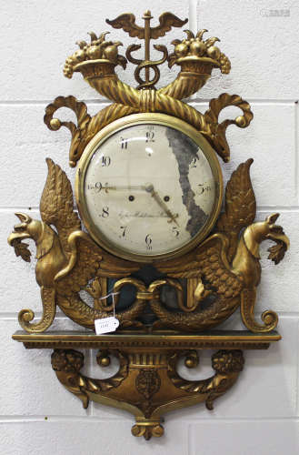 A late 19th century Swedish giltwood wall clock with eight day movement striking on a bell, the