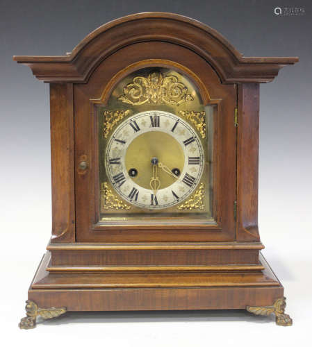 An early 20th century German walnut mantel clock with eight day Junghans movement striking on gongs,