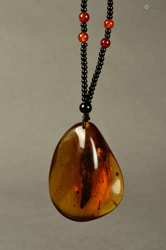 A Chinese Carved Amber Pendant