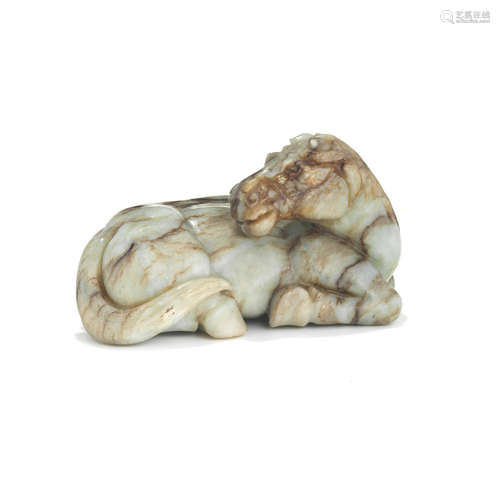 A jade carving of a recumbent horse with russet veins