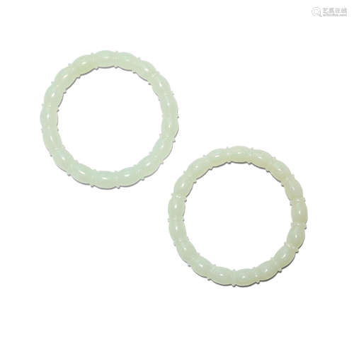 A pair of jade bangles with lobed design