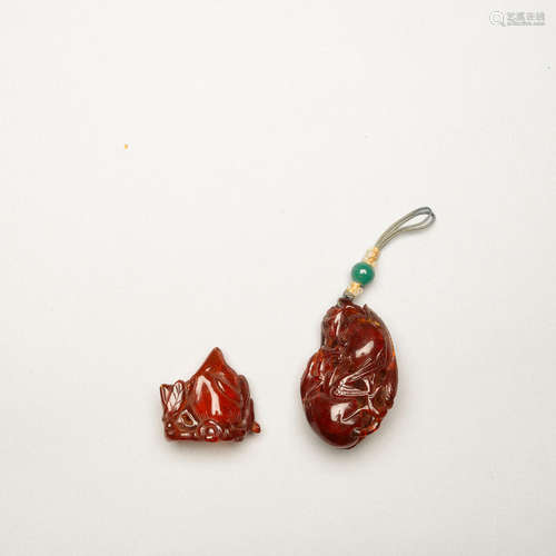 TWO AMBER 'PEACH' ORNAMENTS Qing dynasty