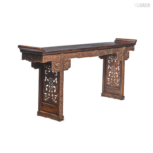 An massive carved hardwood trestle table  20th century