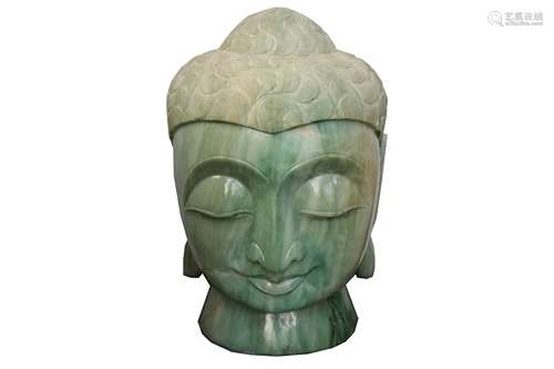 A large Chinese carved jade Buddha head