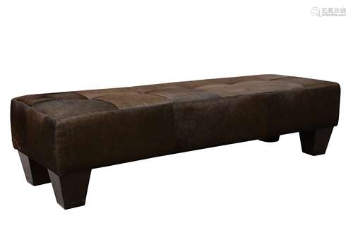 A contemporary cow hide upholstered stool