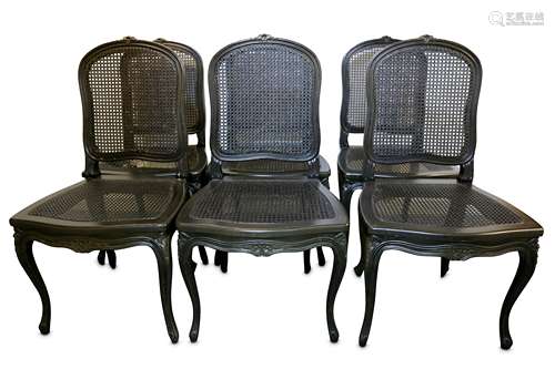 A set of six blackened oak and caned French Louis XV style dining chairs, with carved foliate