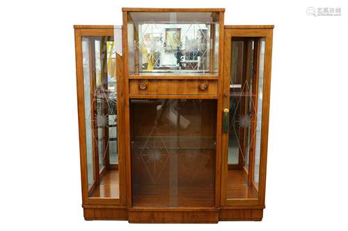 An Art Deco figured walnut breakfront display cabinet