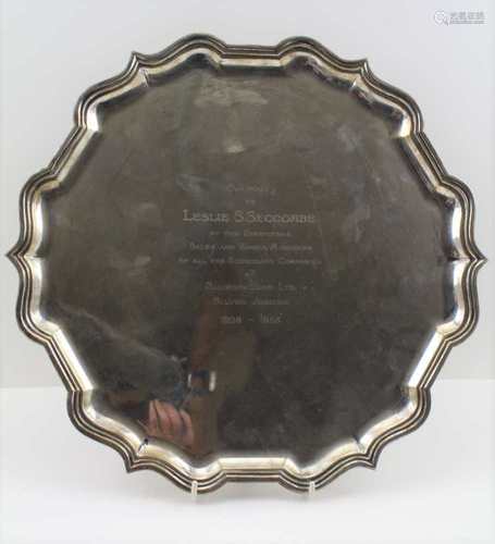 GOLDSMITHS & SILVERSMITHS CO. A GEORGIAN DESIGN SILVER SALVER, with piecrust rim on four pad feet