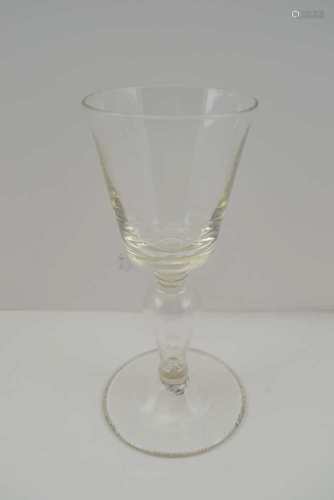 A GEORGIAN DESIGN WINE GLASS with trumpet bowl and seven bubble inclusions to the base, baluster