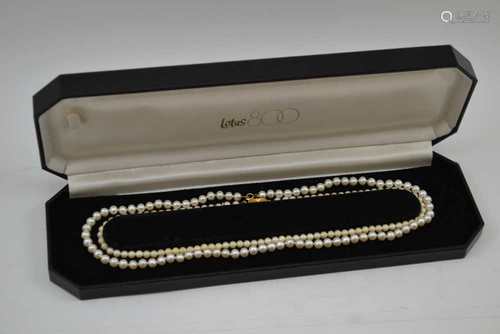 A CULTURED PEARL SINGLE STRAND NECKLACE with 9ct gold clasp, 44cm long, together with a SIMULATED