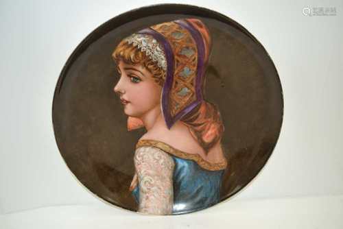 A LATE 19TH CENTURY HAND-PAINTED POTTERY CHARGER in the Vienna manner, decorated with the profile