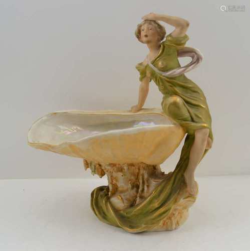 A ROYAL DUX CERAMIC CENTRE PIECE modelled as an open shell bowl, a young woman seated on the edge,