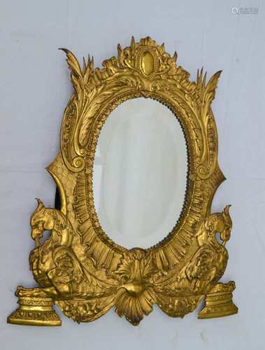 A LATE 19TH CENTURY PROBABLE CONTINENTAL PRESSED METAL FRAMED OVAL BEVELLED WALL MIRROR, with angels