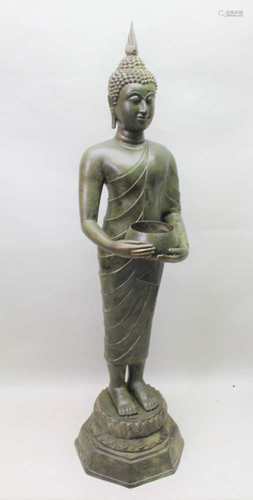 A TEMPLE SCALE THAI BRONZE SUKHOTHAI BUDDHA, represented as a monk carrying rice or alms bowl,