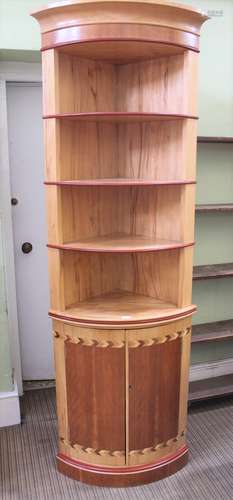 JOHN NETHERCOTT A CONTEMPORARY CRAFTSMAN MADE TWO-PIECE BOW FRONT CORNER UNIT, having open shelved