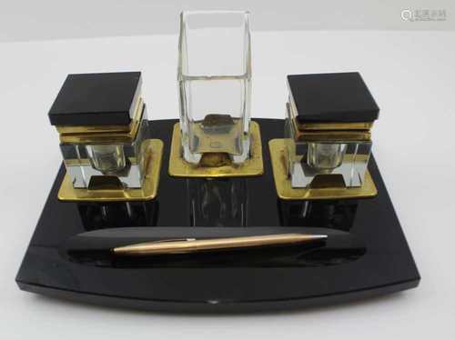 AN ART DECO STANDISH, black glass base with pen rest, fitted two glass wells flanking a central