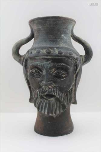 A THRACIAN POTTERY VASE, of baluster form, with mask decoration, fitted two shoulder handles,