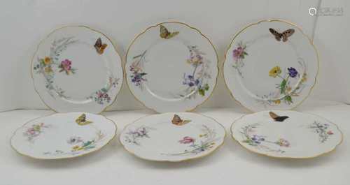 A SET OF TWELVE SEVRES-MACE PORCELAIN DESSERT PLATES, floral and butterfly decorated, by Louis