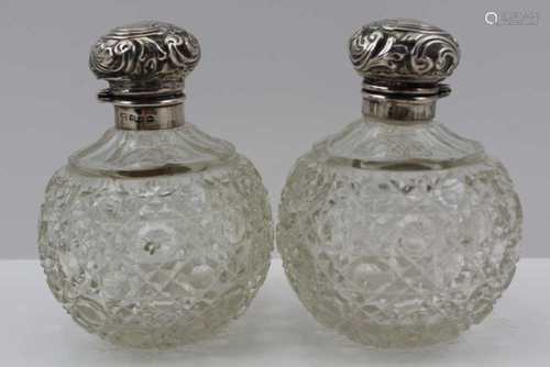 LEVI AND SALAMAN A PAIR OF LATE 19TH CENTURY SILVER TOPPED CUT GLASS GRENADE FORM SCENT BOTTLES, one