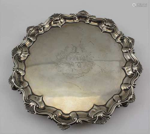 A GEORGE II SILVER SALVER, shell cast rim, raised on three platform feet, engraved armorial, with