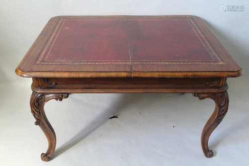 A LATE 19TH CENTURY MAHOGANY TABLE, having later insert tooled skiver top, supported on four fancy