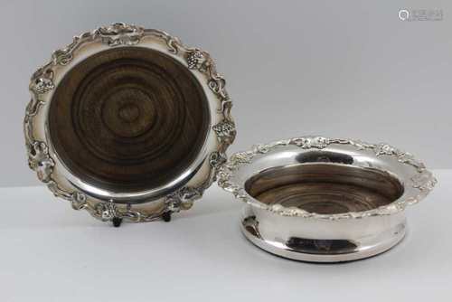 A PAIR OF GEORGIAN DESIGN SILVER-PLATED BOTTLE COASTERS, with cast fruiting vine rims, turned wood