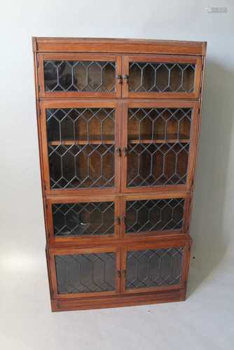 A MID 20TH CENTURY OAK FINISHED FOUR SECTION ESAVIAN OF LONDON BOOKCASE, having decorative leaded