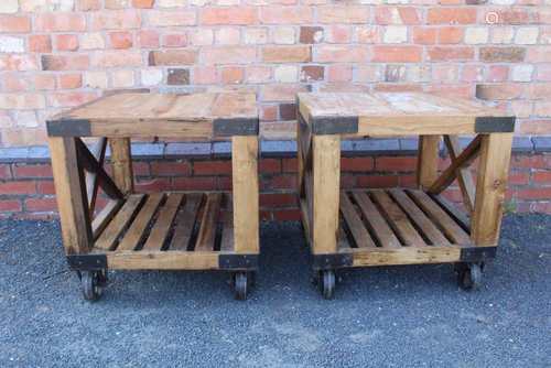 A PAIR OF INDUSTRIAL CHIC RECLAIMED WOODEN TABLE / STANDS having metal strap banding and castors