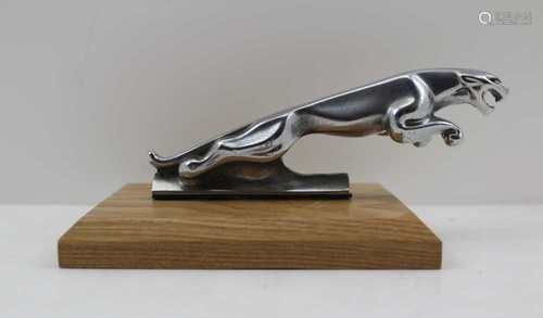 A CHROME JAGUAR CAR MASCOT, believed to be from an XJ6, 12cm, mounted upon an oak base