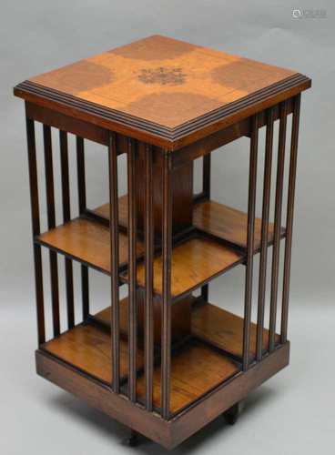 A 20TH CENTURY MIXED WOOD REVOLVING BOOKCASE, of typical form and construction, having fancy