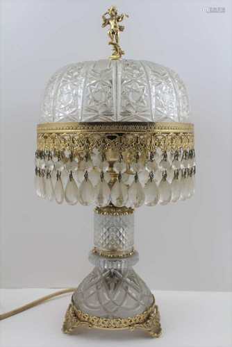 AN ORNATE GLASS & BRASS TABLE LAMP, the shade with cherub finial and tear droppers, on shell foot