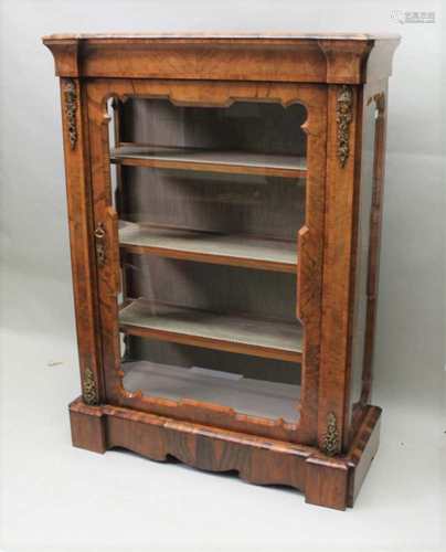 A 19TH CENTURY WALNUT DISPLAY CABINET, having applied cast brass finished mouldings, of