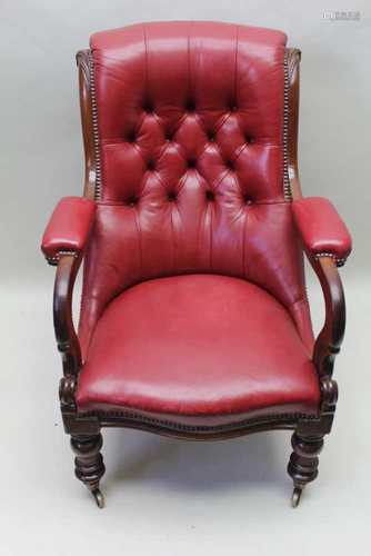 A REGENCY MAHOGANY FRAMED LIBRARY STYLE ARMCHAIR with claret leather upholstery, having buttoned