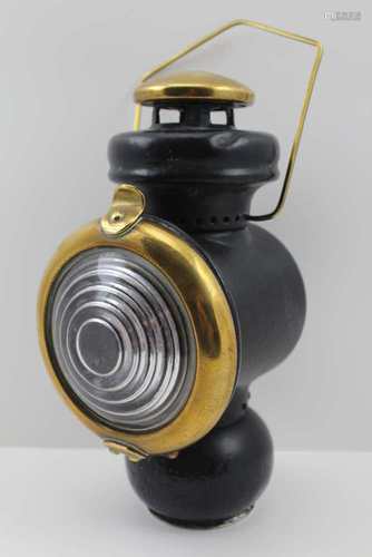 A LANTERN WITH BLACK PAINTED METAL & BRASS FRAME, fitted brass carry handle and clear bullseye lens,