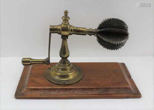 A 19TH CENTURY COCONUT FLESH SHREDDER/SCRAPER of brass construction, with crank handle, steel