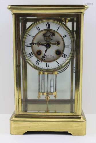 SAMUEL MARTI A BRASS FOUR-GLASS MANTEL CLOCK, white enamel dial with Roman numerals, recessed centre