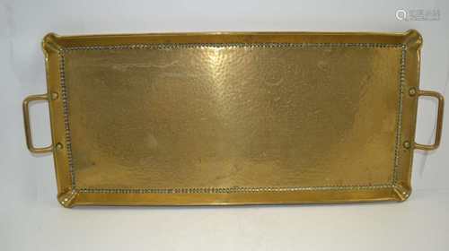 AN ARTS & CRAFTS PLANISHED BRASS TRAY, of rectangular form with gallery and two open handles, 27cm x