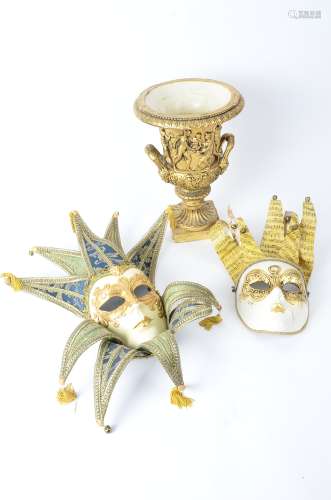 A pair of Italian Venetian style masks, together with an ornate gilt vase in the campagna shape,