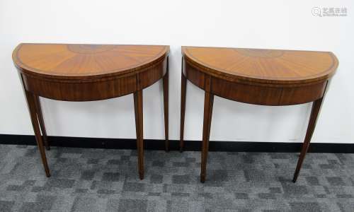 A pair of George III Sheraton style demilune satinwood card tables, the tops having boxwood and