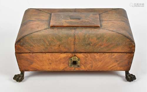 An 18th Century tortoiseshell cushion shaped casket, with gilt metal floral and ball feet, on a