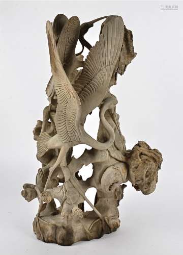A large Malay carving, depicting herons catching fish and crabs, height approximately 67cm