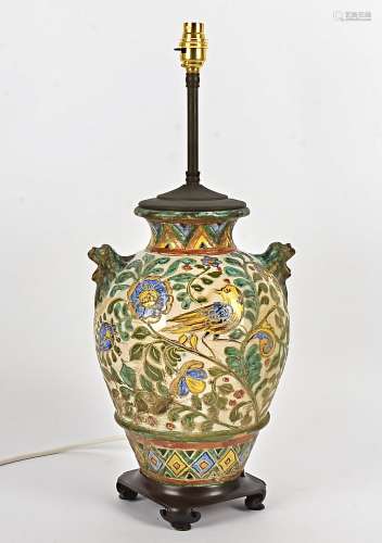 A Portuguese maiolica style table lamp, decorated with birds and foliage and twin handles in the