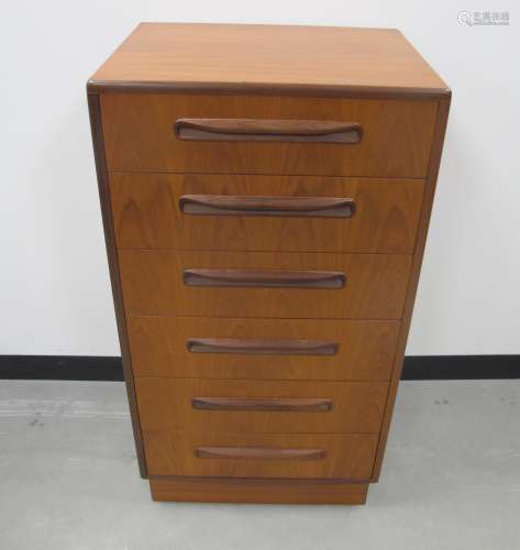A mid-century teak G plan Fresco tall boy chest, with six long drawers on plinth base, makers