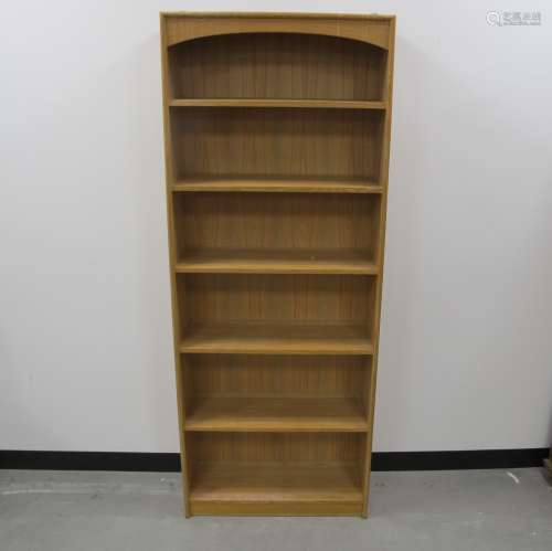 A Cotswold School style open bookcase, oak frame with panelled sides and five fixed shelfs, 71cm x