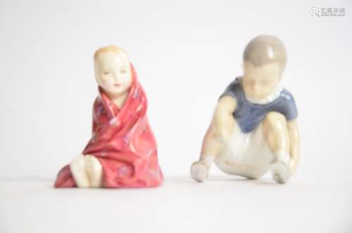 Two childhood figures, one a Bing & Grondahl boy sat down and reaching forward for something on