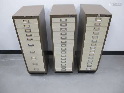 Three Bisley metal office filing cabinets, two with fifteen drawers the other ten, measuring 28cm