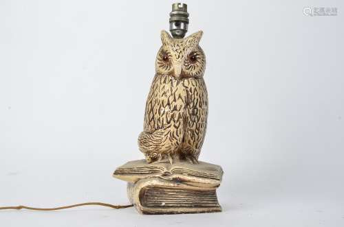 An early 20th Century plaster lamp base in the form on an owl, with orange glass eyes, height of