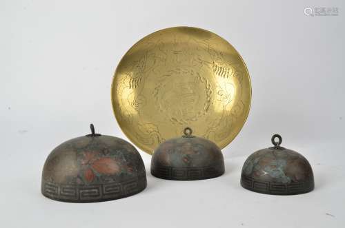 A graduated trio of Asian metalwork bells, with key fret lower borders and floral decoration,